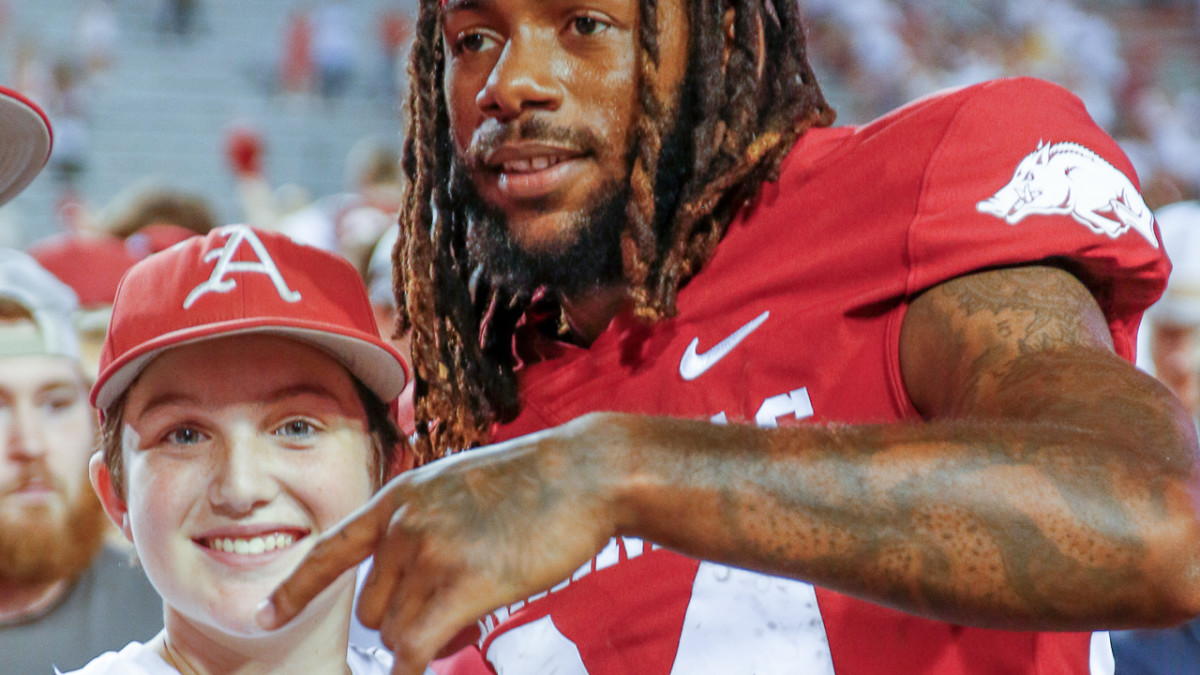 Razorbacks receiver Warren Thompson celebrating Texas win with fans
